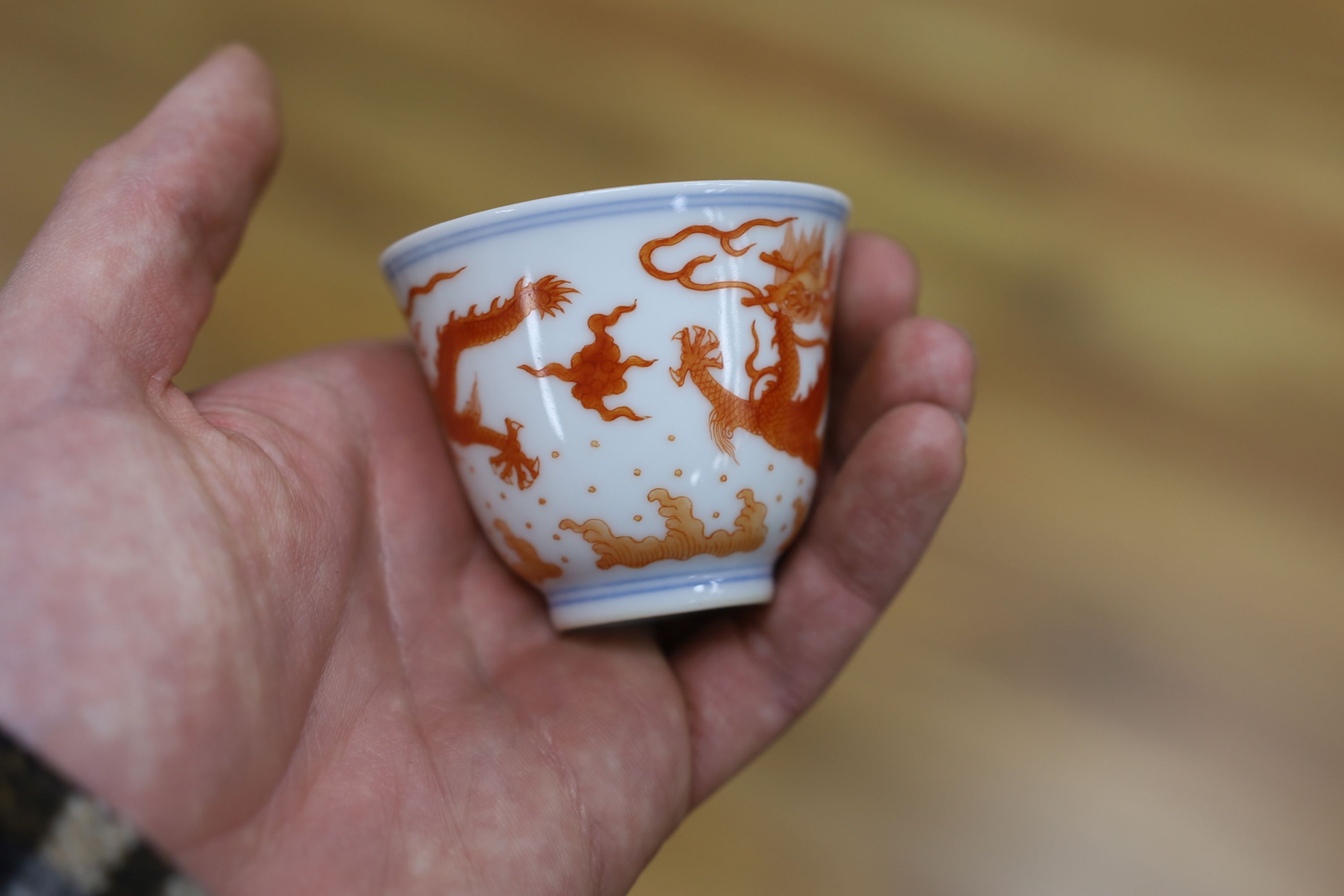 A Chinese iron red enamelled ‘dragon’ tea bowl, 5cm high